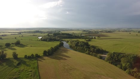 Rural-landscape-in-France.-Fields,-river,-trees-view-by-drone.-Day-time